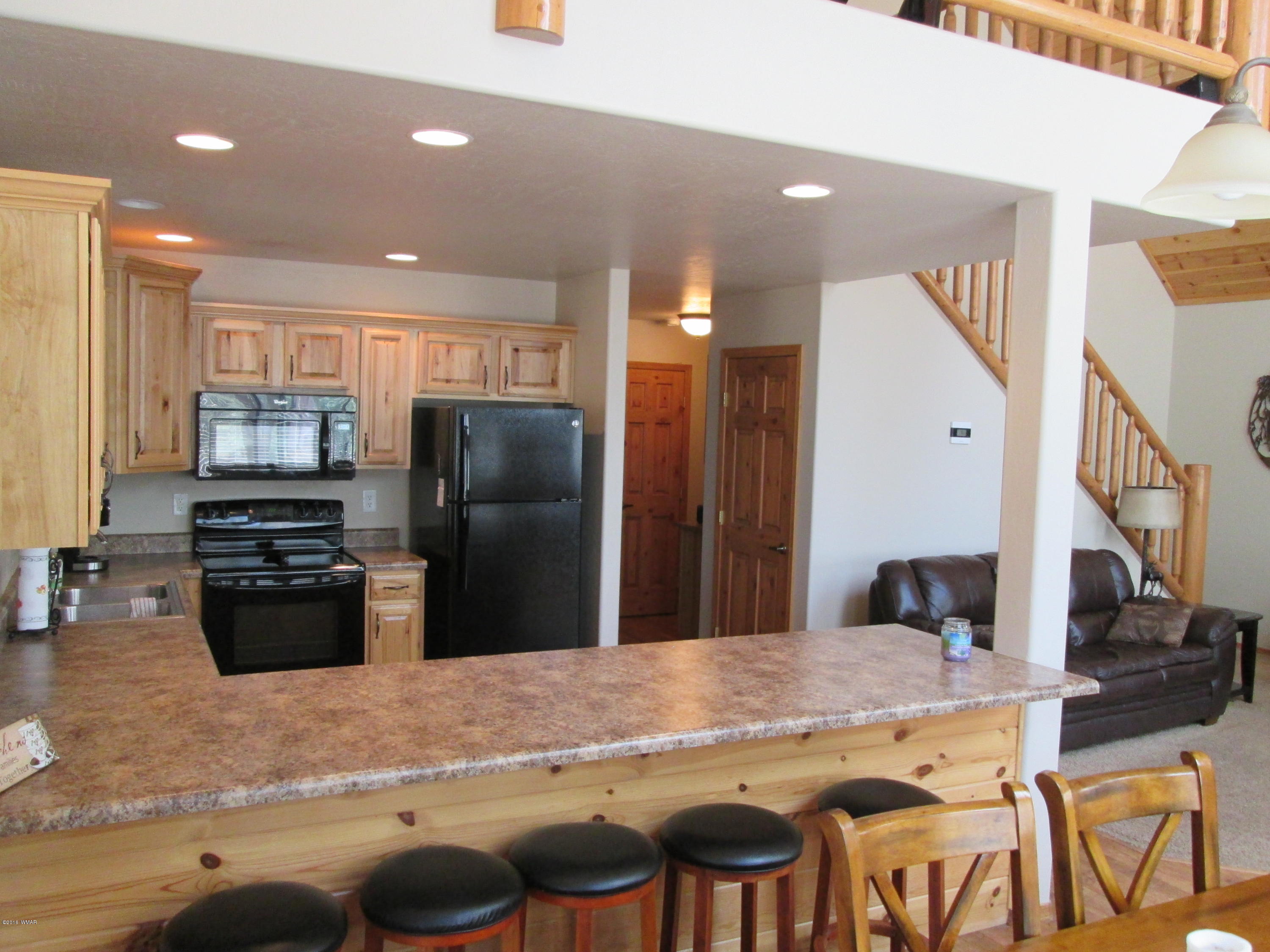 3048 Aspen Road Overgaard, AZ 85933 - Photo 17 of 36 a kitchen with stainless steel appliances granite countertop a stove refrigerator and cabinets