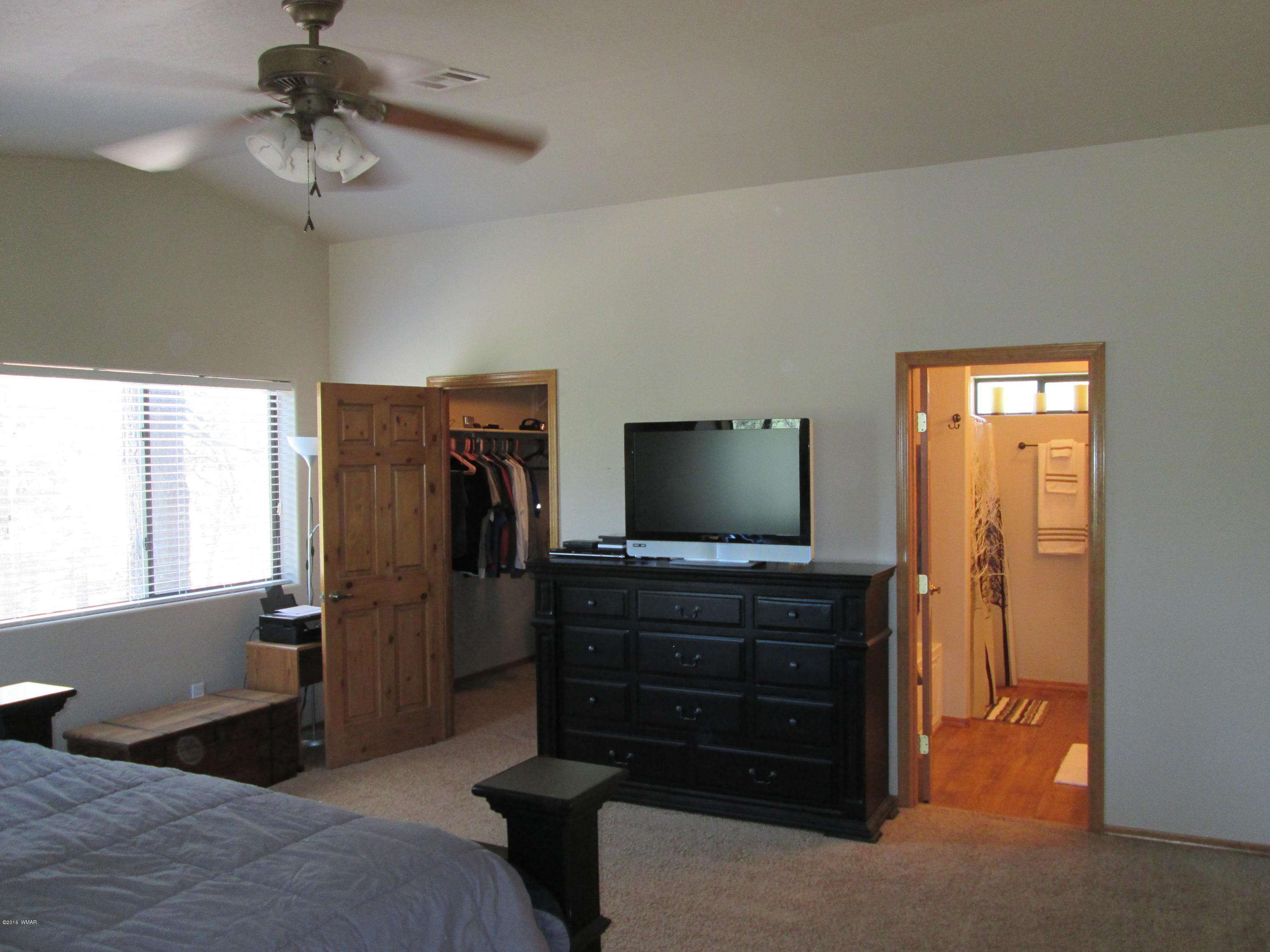 3048 Aspen Road Overgaard, AZ 85933 - Photo 21 of 36 a living room with furniture and a flat screen tv