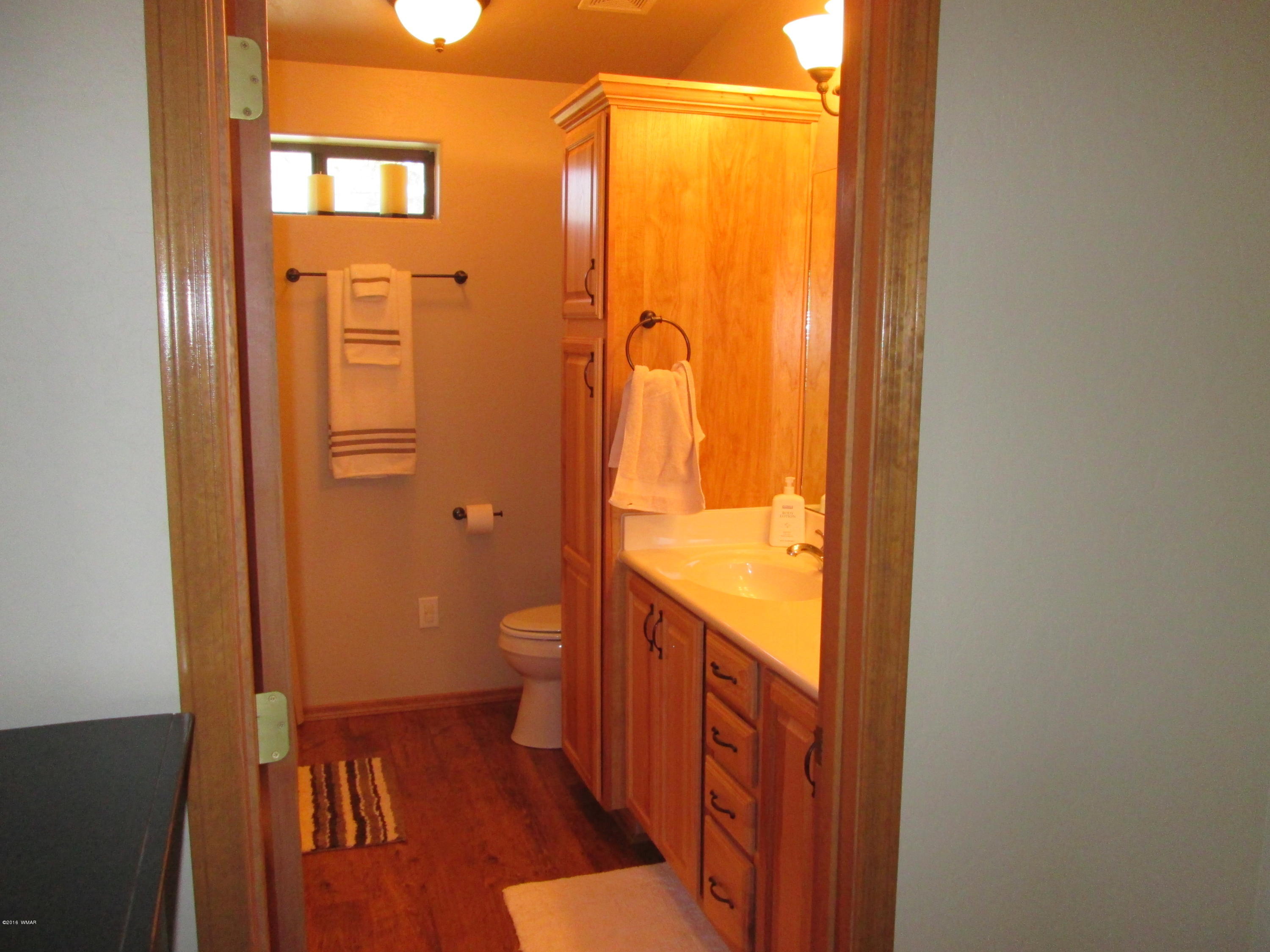 3048 Aspen Road Overgaard, AZ 85933 - Photo 23 of 36 a bathroom with a shower and toilet