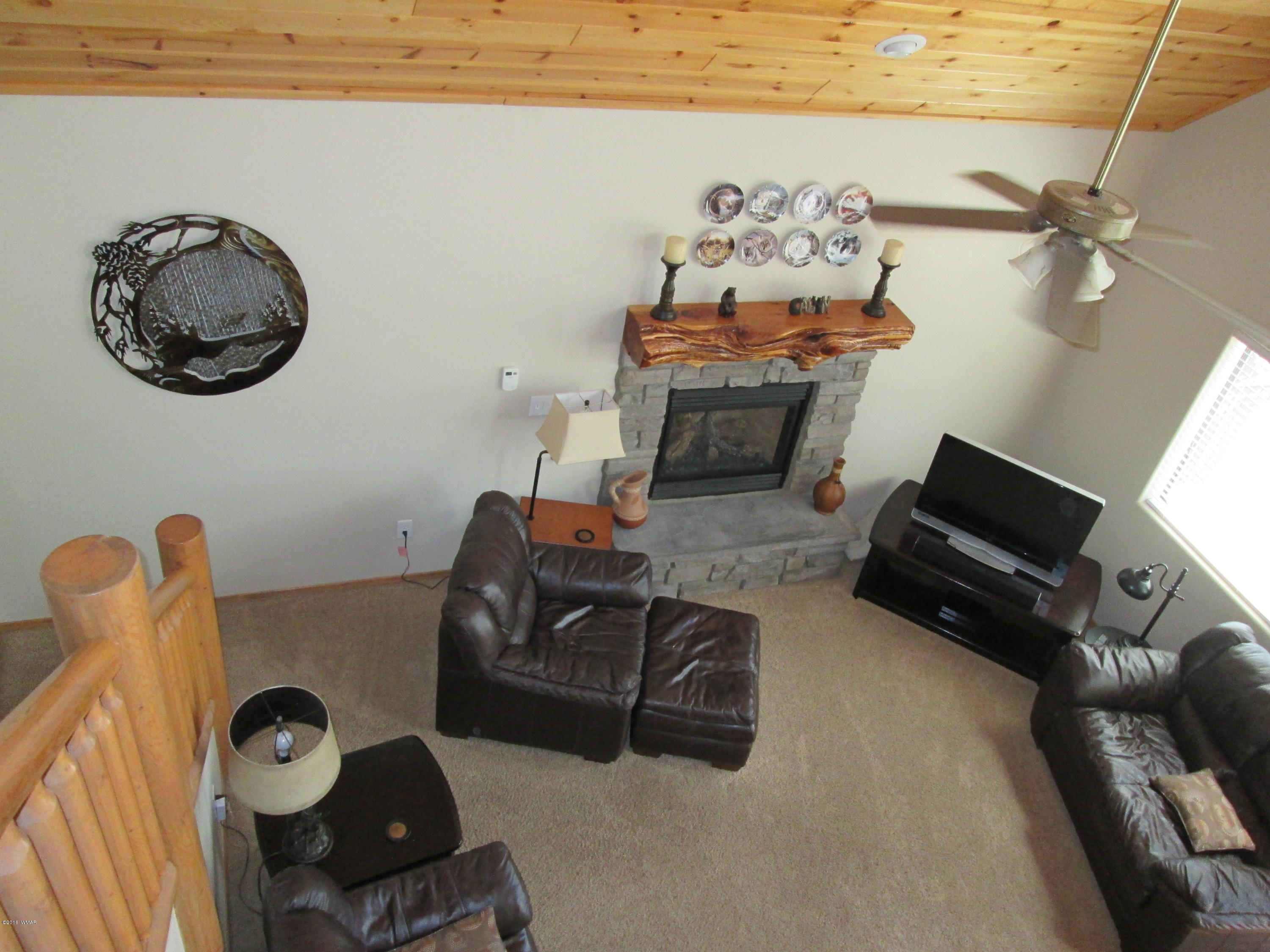 3048 Aspen Road Overgaard, AZ 85933 - Photo 25 of 36 a living room with furniture and a flat screen tv