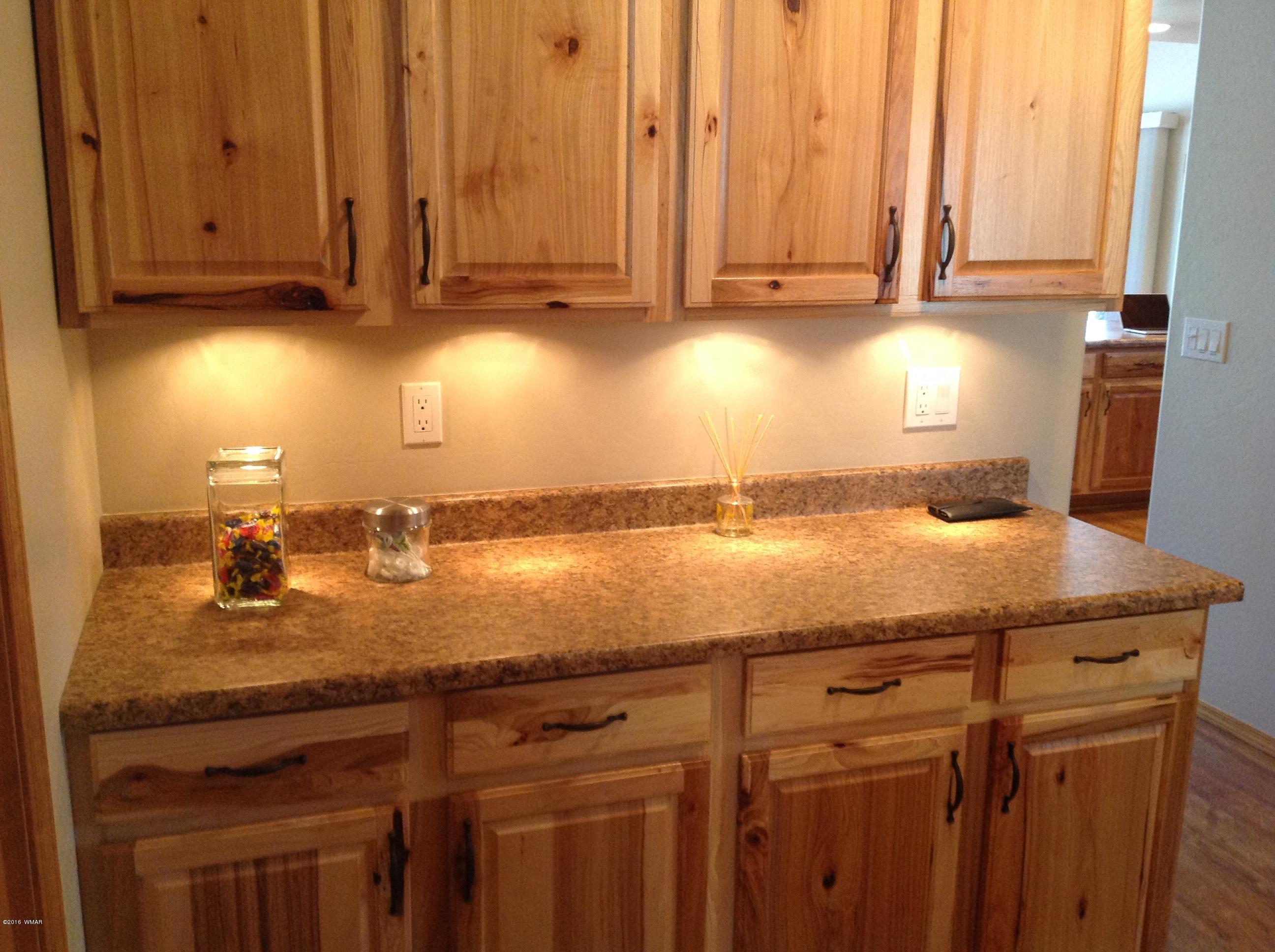 3048 Aspen Road Overgaard, AZ 85933 - Photo 26 of 36 a bathroom with a granite countertop sink and a vanity