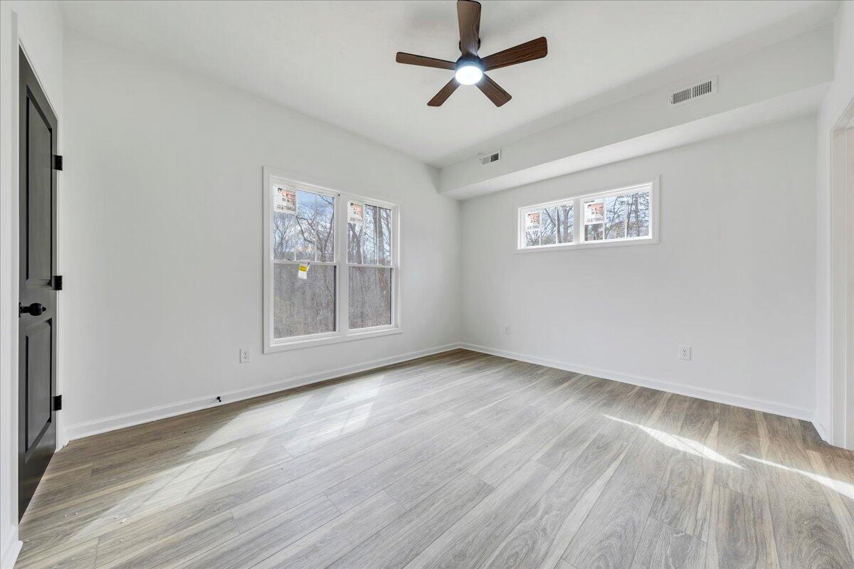 610 Gap Bridge Road Moneta, VA 24121 - Photo 13 of 62 a view of empty room with wooden floor and fan