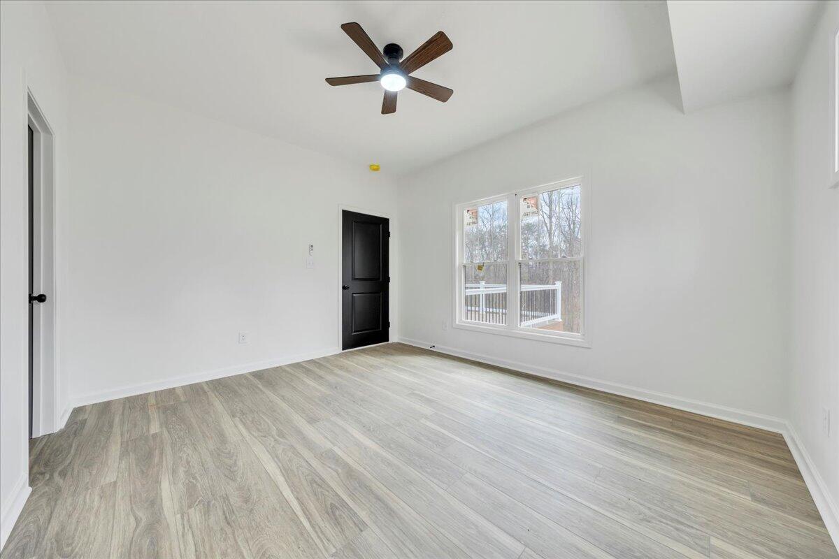 610 Gap Bridge Road Moneta, VA 24121 - Photo 14 of 62 a view of an empty room with a window and wooden floor