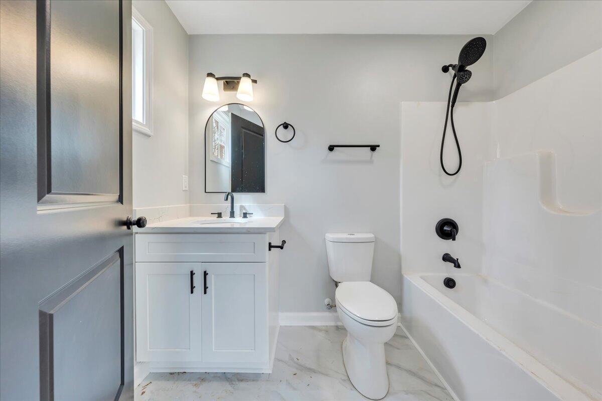 610 Gap Bridge Road Moneta, VA 24121 - Photo 15 of 62 a bathroom with a toilet sink and shower