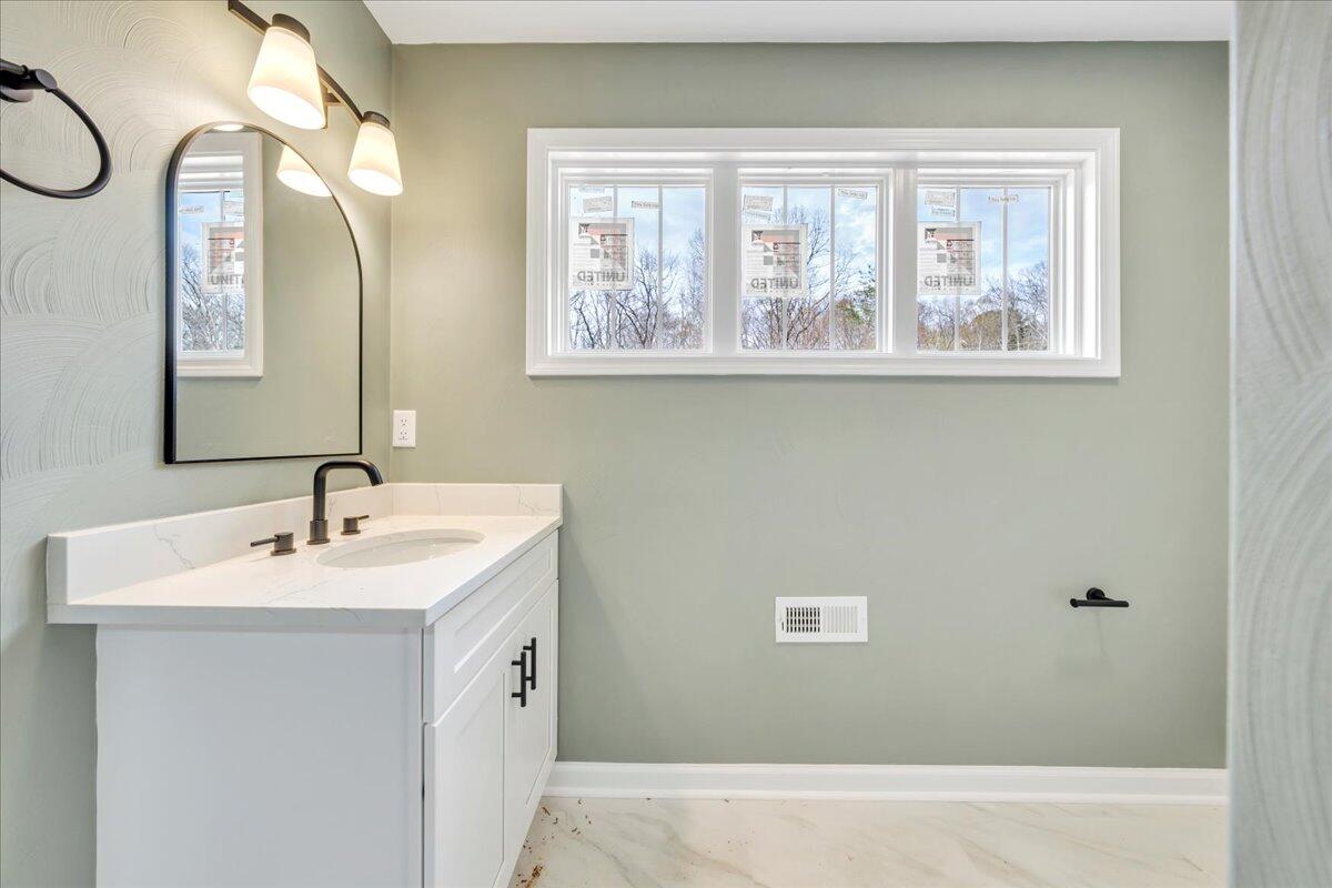 610 Gap Bridge Road Moneta, VA 24121 - Photo 22 of 62 a bathroom with a sink a mirror and a window