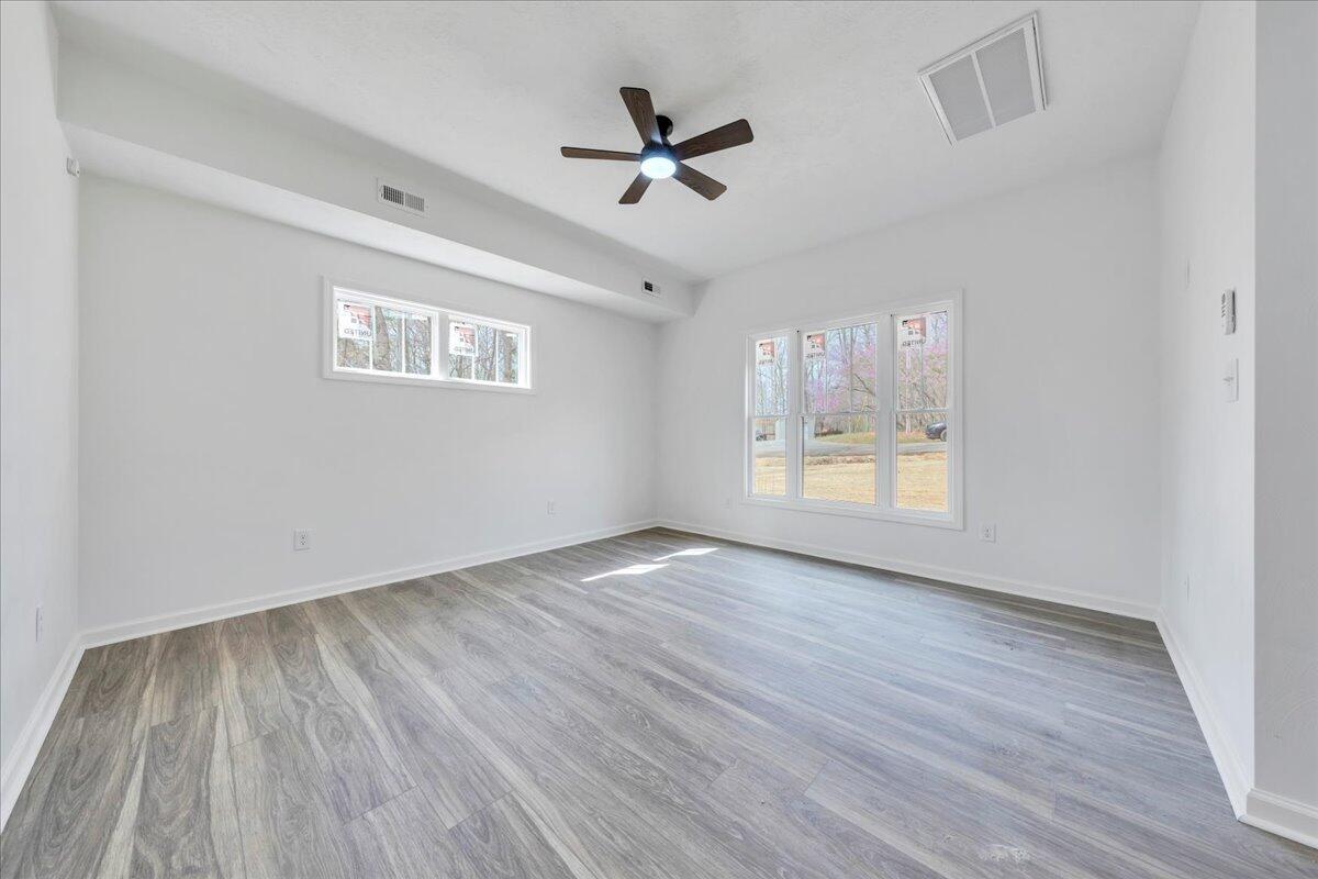 610 Gap Bridge Road Moneta, VA 24121 - Photo 3 of 62 wooden floor in an empty room with a window