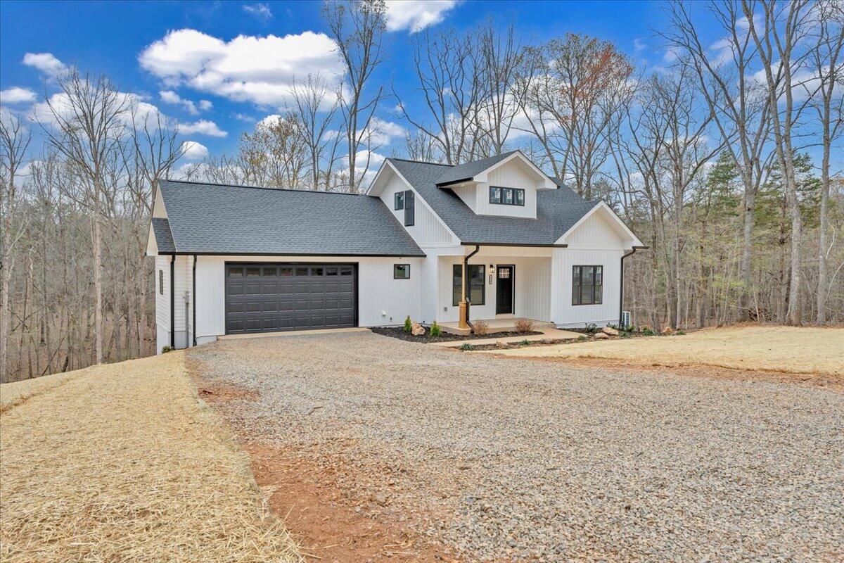 610 Gap Bridge Road Moneta, VA 24121 - Photo 32 of 62 a front view of a house with a yard and garage