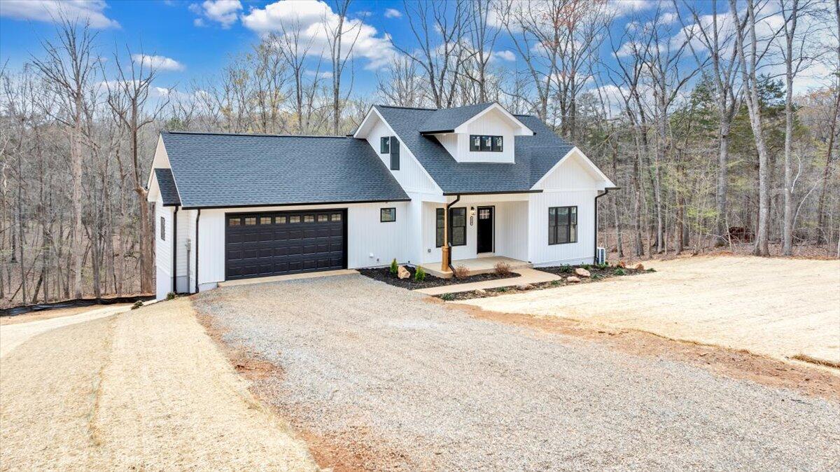 610 Gap Bridge Road Moneta, VA 24121 - Photo 38 of 62 a front view of a house with a yard and garage