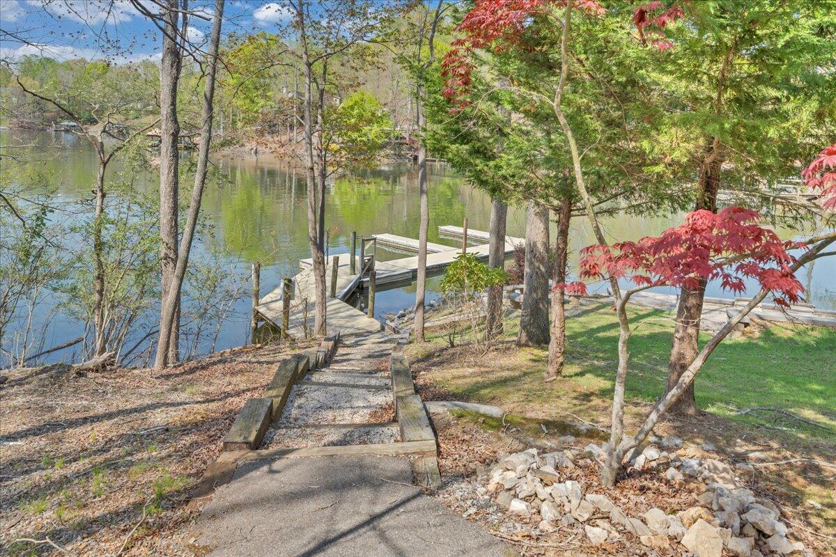 610 Gap Bridge Road Moneta, VA 24121 - Photo 49 of 62 a view of a lake with a bench and trees