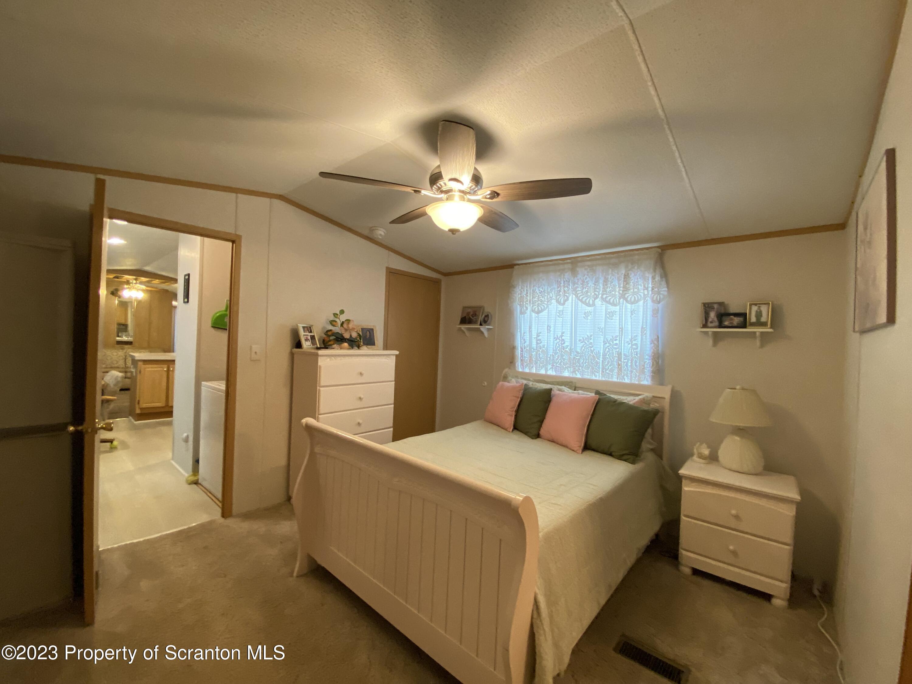 4 Honor Park Moosic, PA 18507 - Photo 11 of 24 a bedroom with a bed and a chandelier