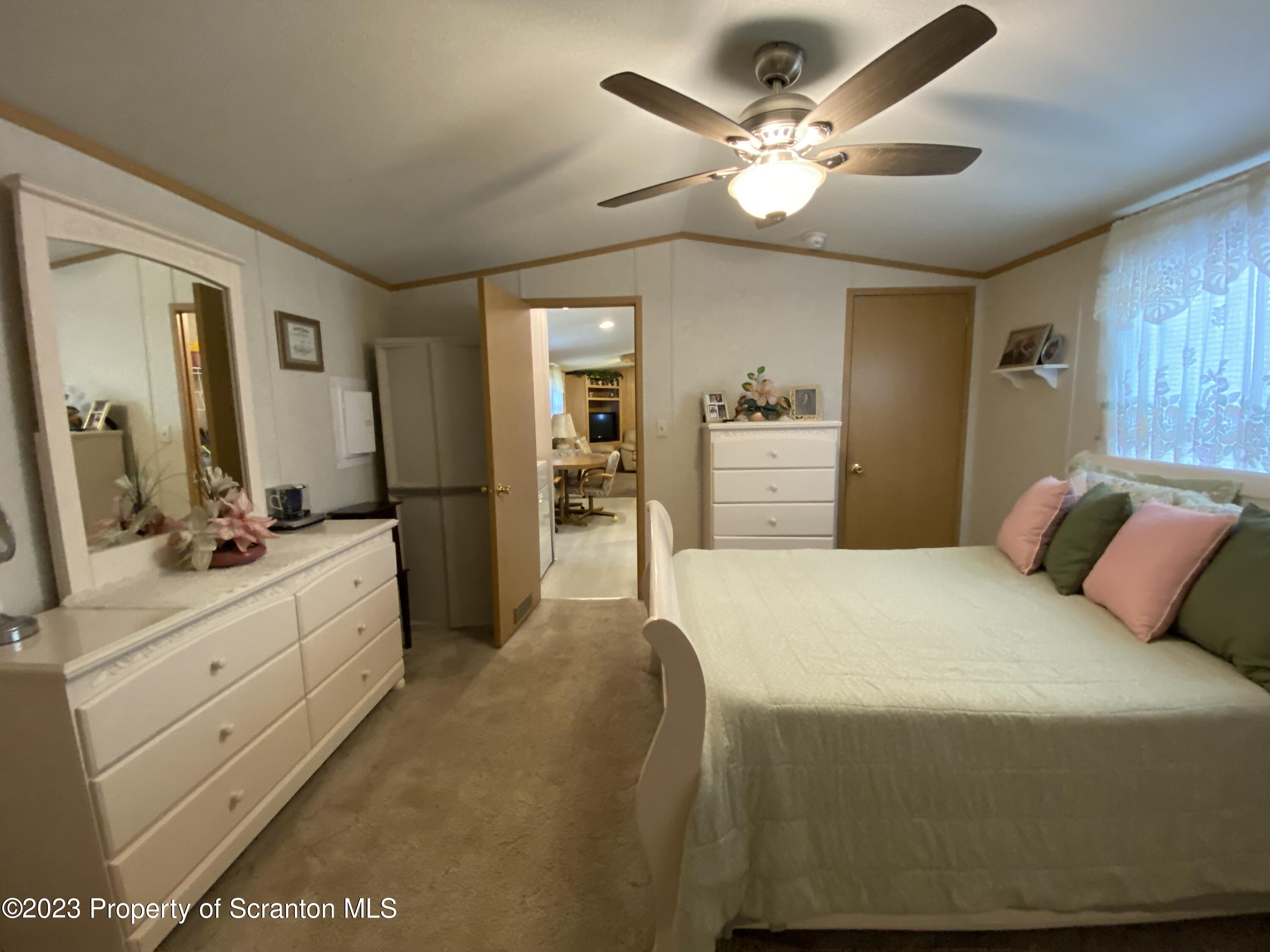 4 Honor Park Moosic, PA 18507 - Photo 13 of 24 a bedroom with a large bed and a chandelier