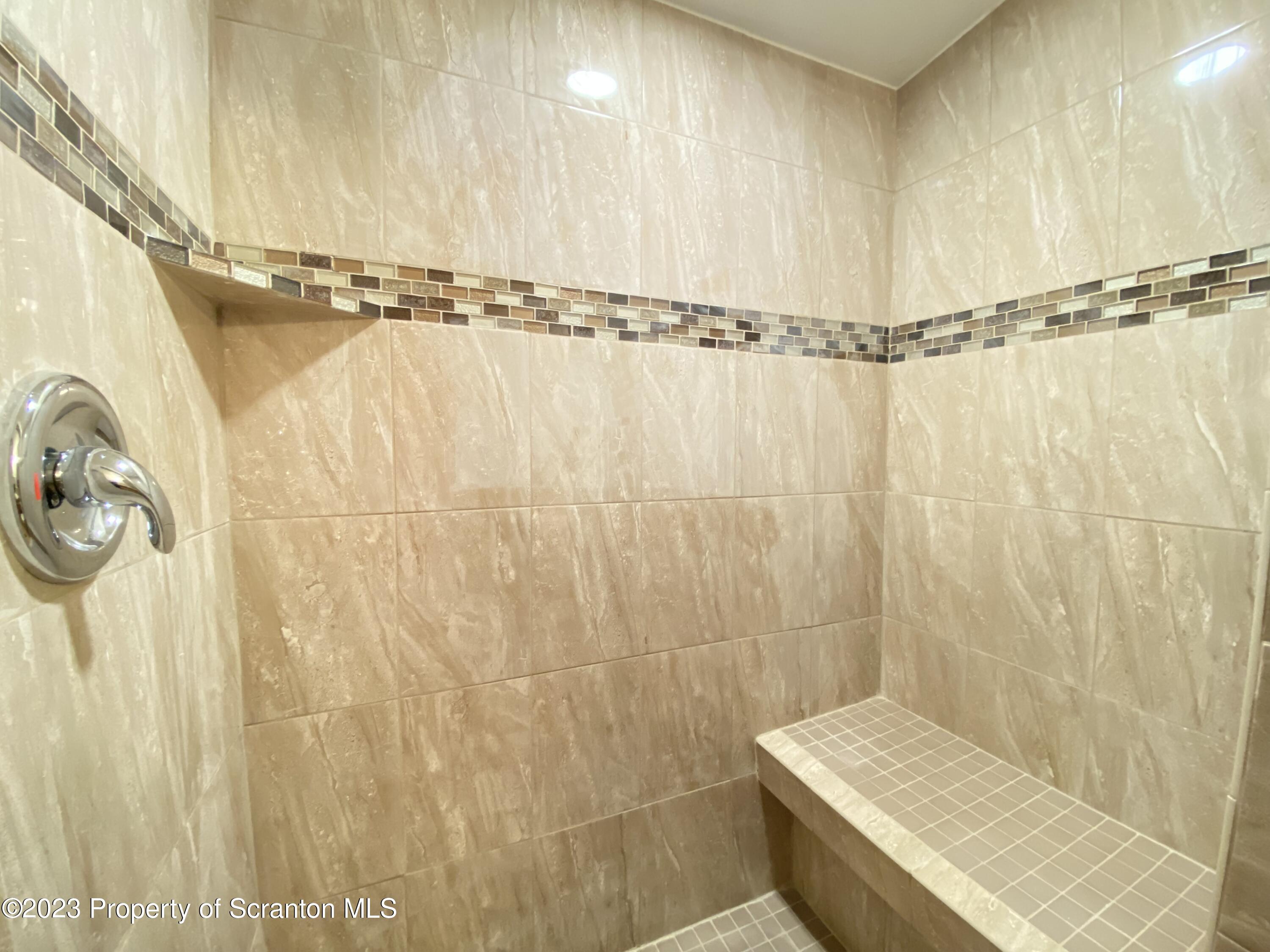 4 Honor Park Moosic, PA 18507 - Photo 16 of 24 a bathroom with a shower curtain and a window