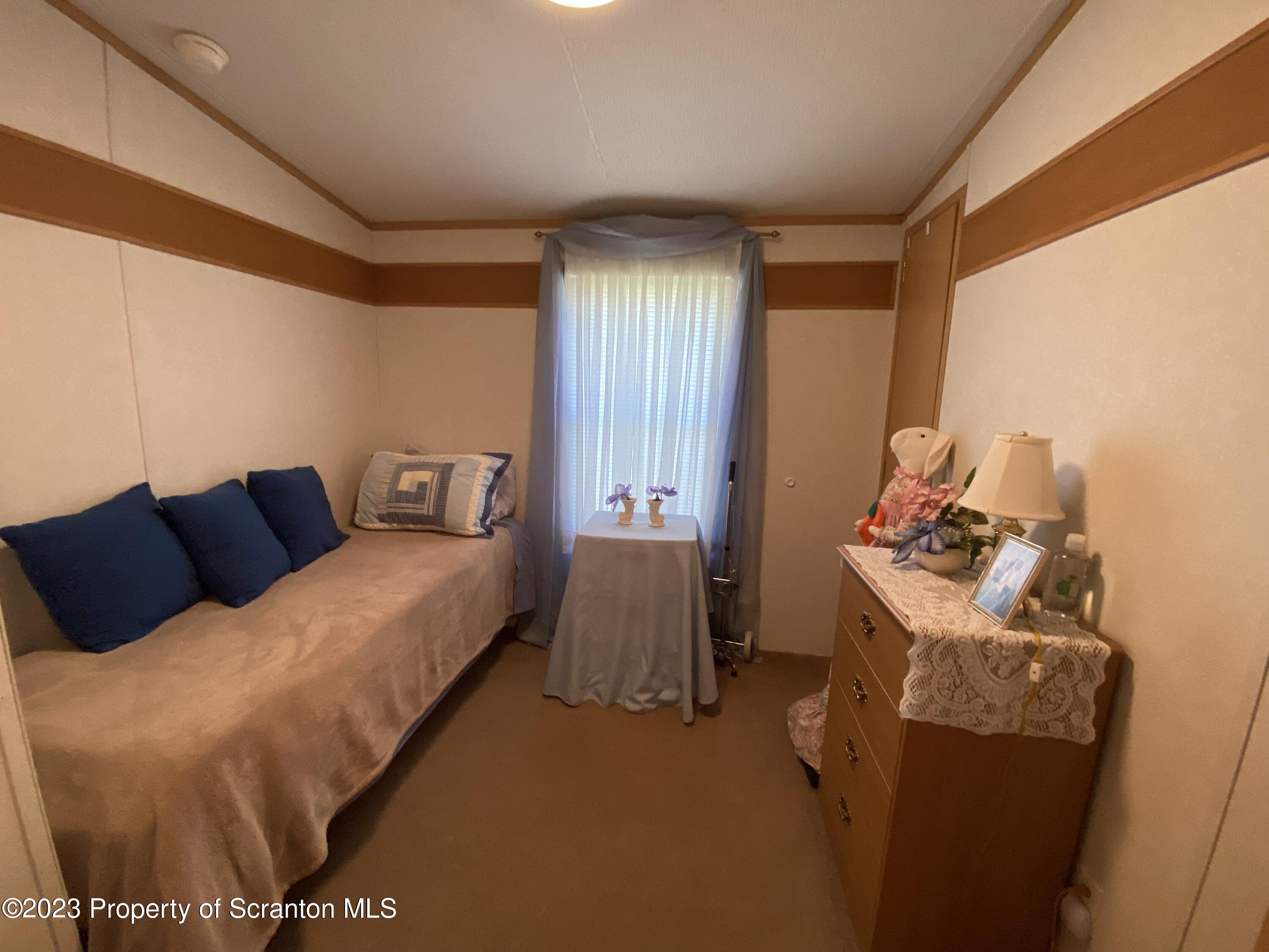 4 Honor Park Moosic, PA 18507 - Photo 19 of 24 a bedroom with a bed and a table