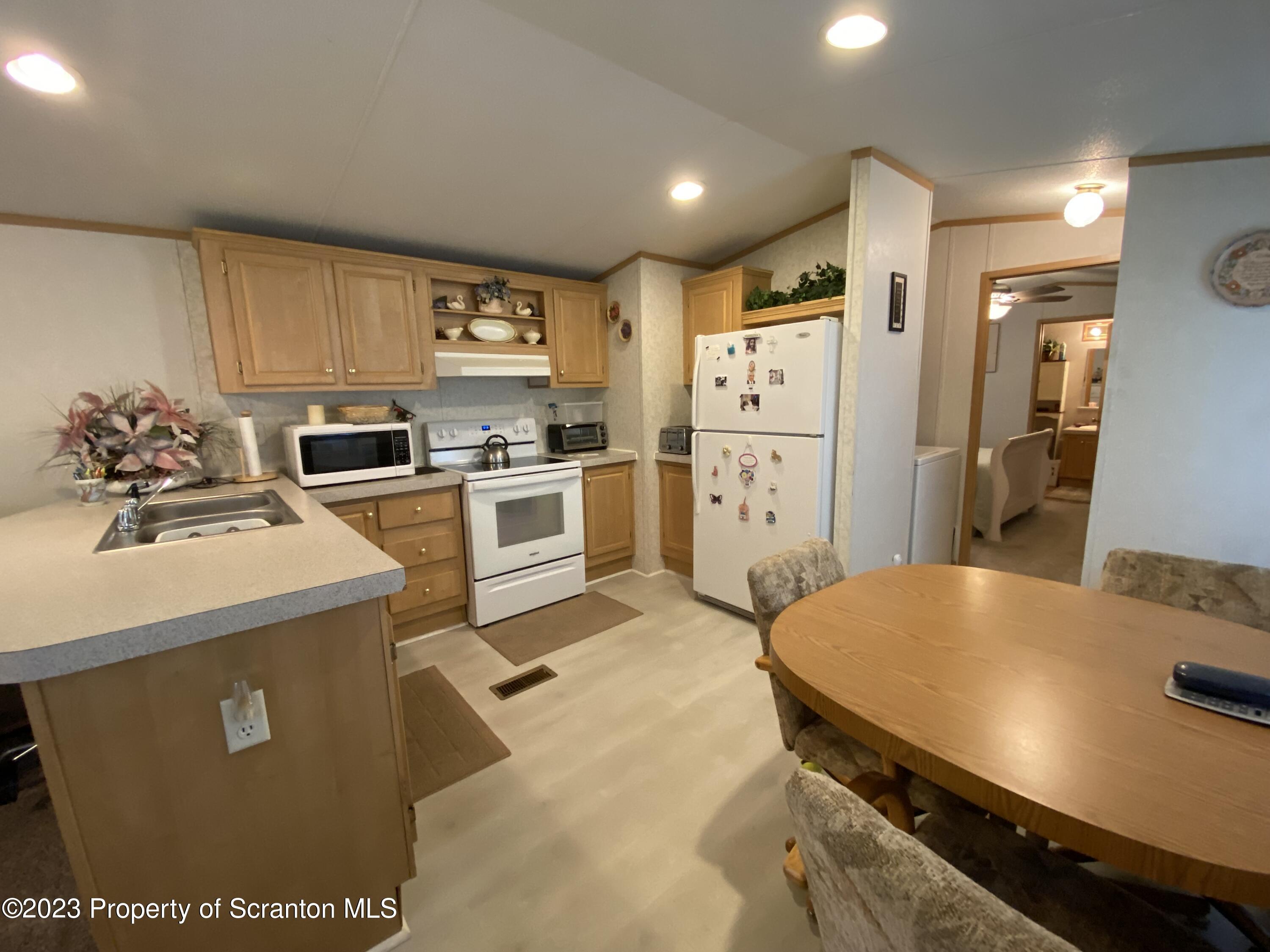 4 Honor Park Moosic, PA 18507 - Photo 5 of 24 a kitchen with a sink a stove and refrigerator