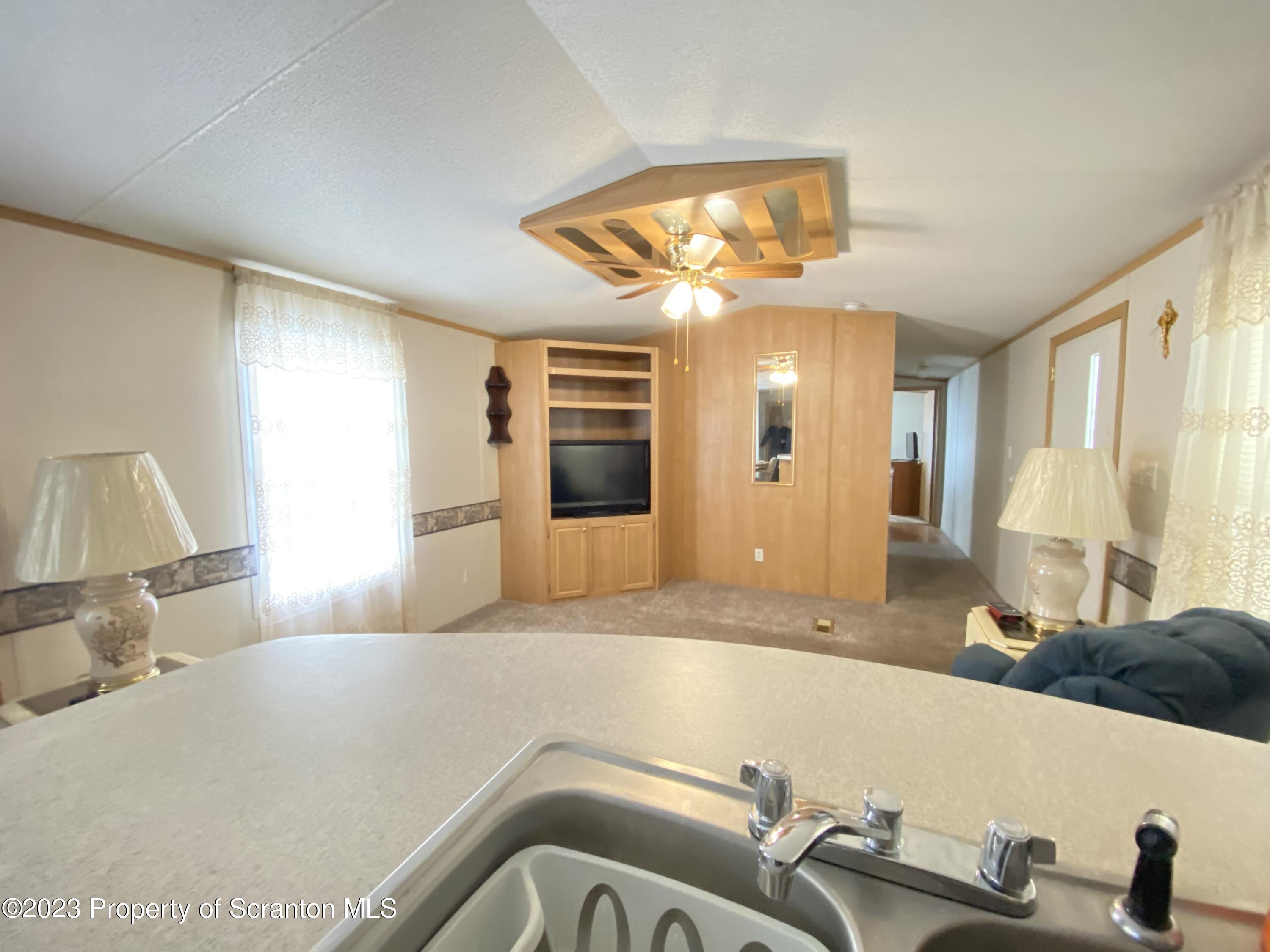 4 Honor Park Moosic, PA 18507 - Photo 6 of 24 a view of a livingroom with a kitchen and a sink