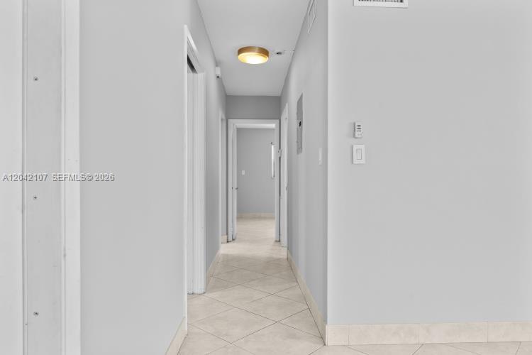 3213 Colony Club Road, Unit 3E Pompano Beach, FL 33062 - Photo 15 of 31 a view of a hallway with wooden floor