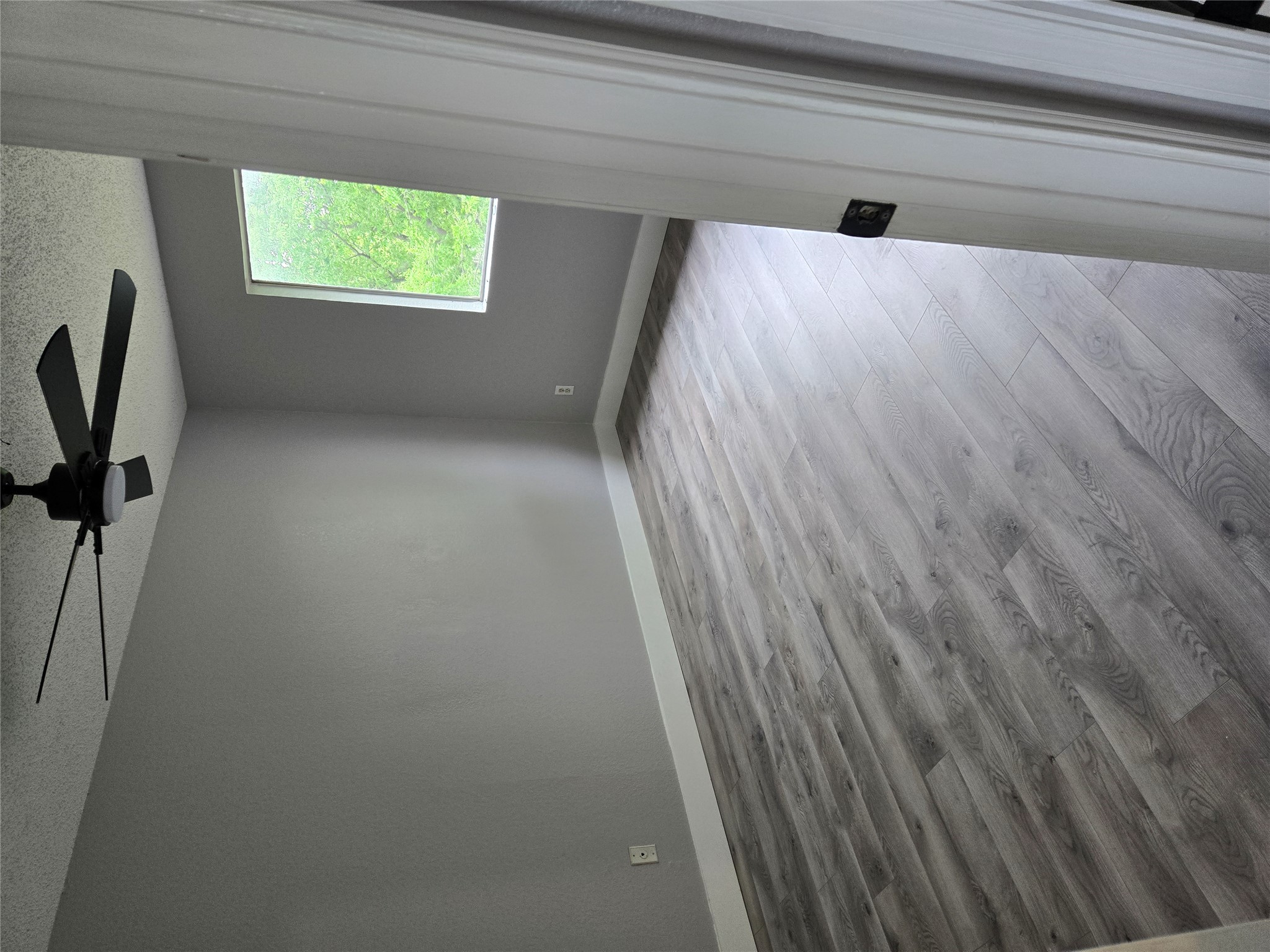 10001 Parliament House Road, Unit A Austin, TX 78729 - Photo 18 of 25 wooden floor in an empty room with a window