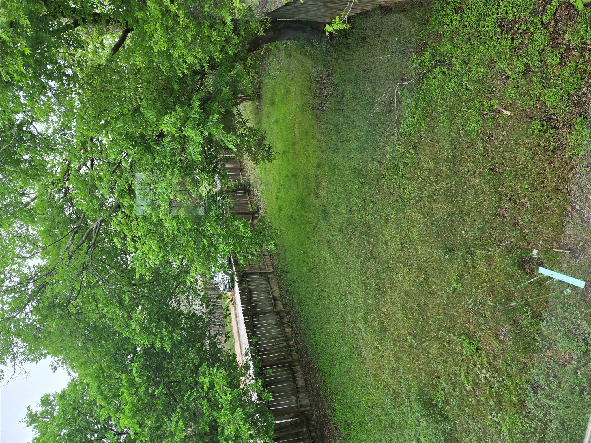 10001 Parliament House Road, Unit A Austin, TX 78729 - Photo 24 of 25 a view of a green field with wooden fence