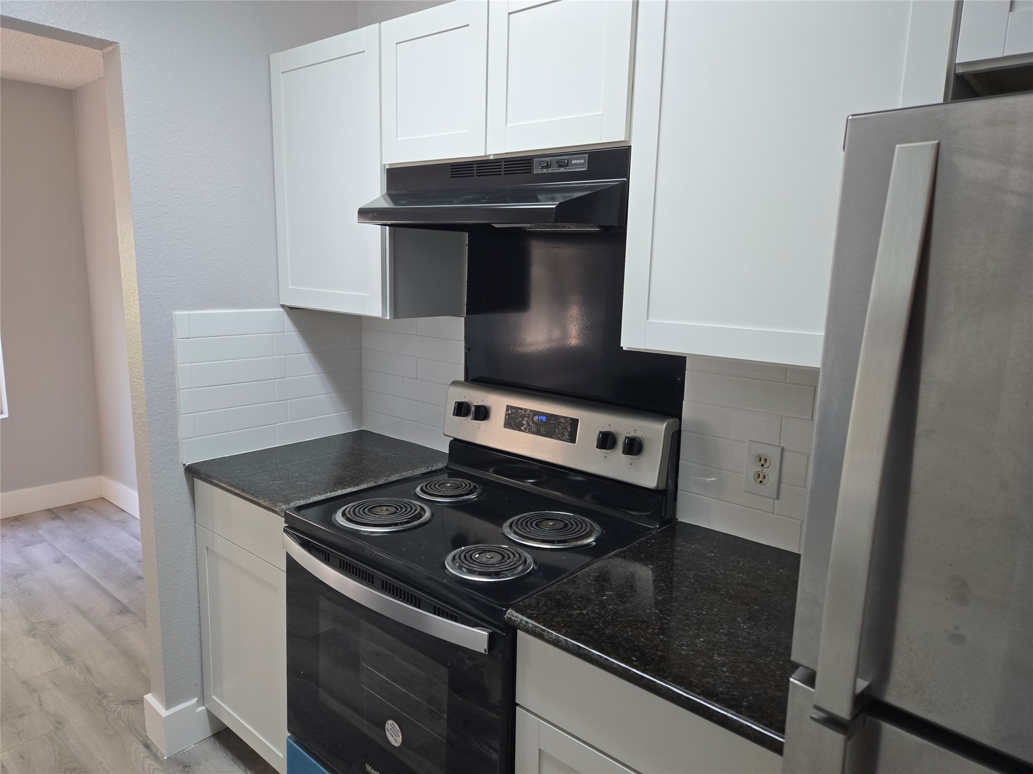 10001 Parliament House Road, Unit A Austin, TX 78729 - Photo 4 of 25 a stove top oven sitting inside of a kitchen