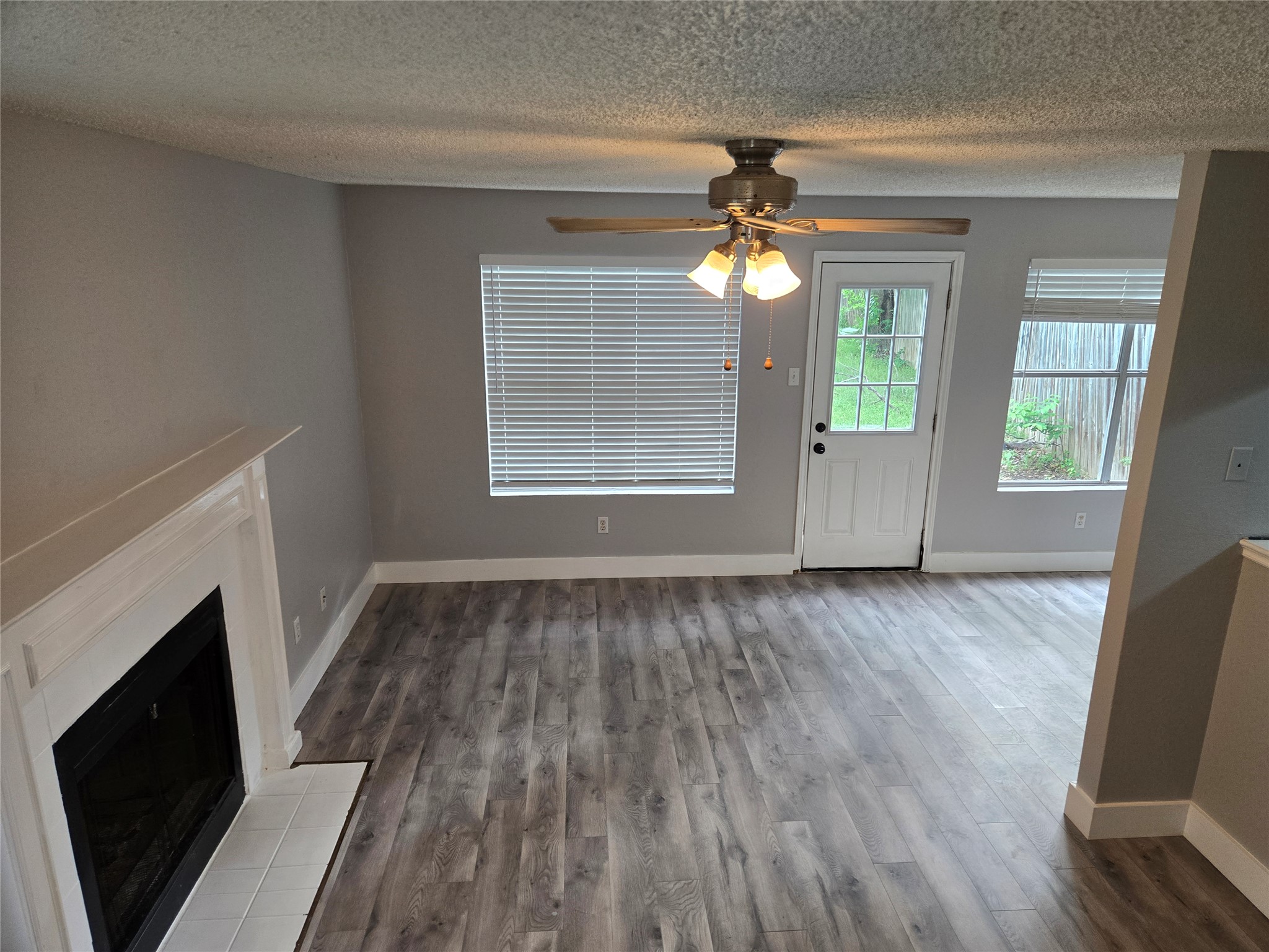 10001 Parliament House Road, Unit A Austin, TX 78729 - Photo 9 of 25 a view of an empty room with wooden floor and a window