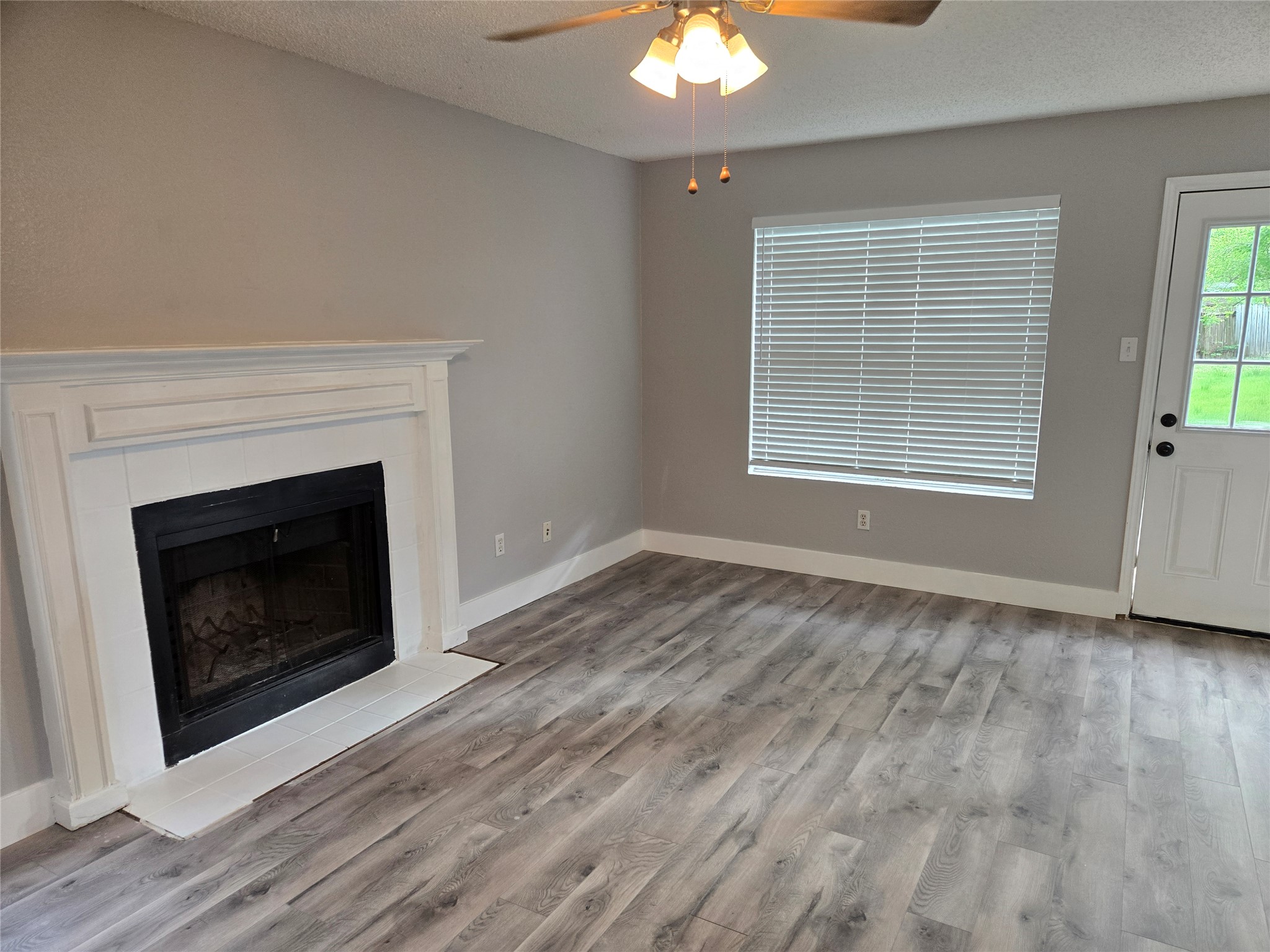 10001 Parliament House Road, Unit A Austin, TX 78729 - Photo 10 of 25 a view of an empty room with a fireplace and a window