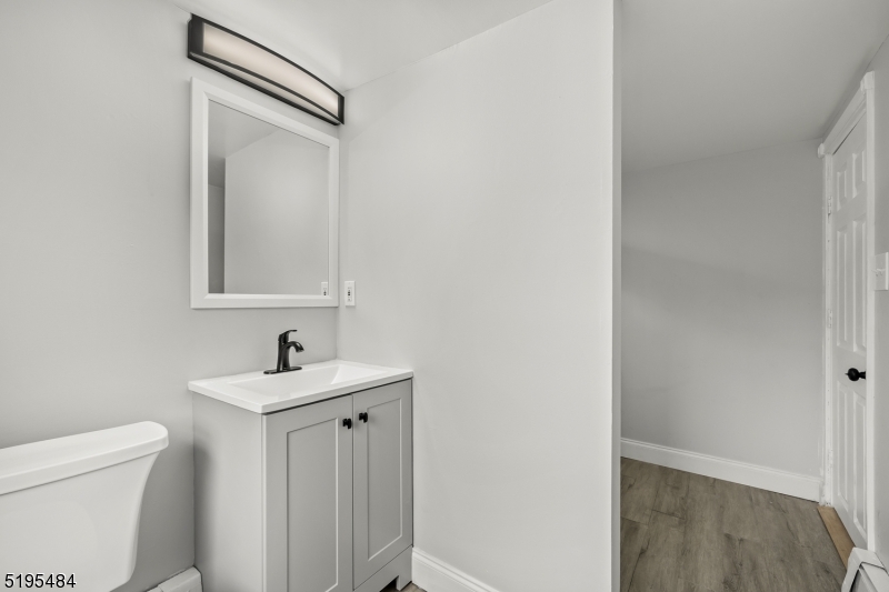 5 North Main Street Wharton, NJ 07885 - Photo 8 of 10 a bathroom with a toilet sink and mirror