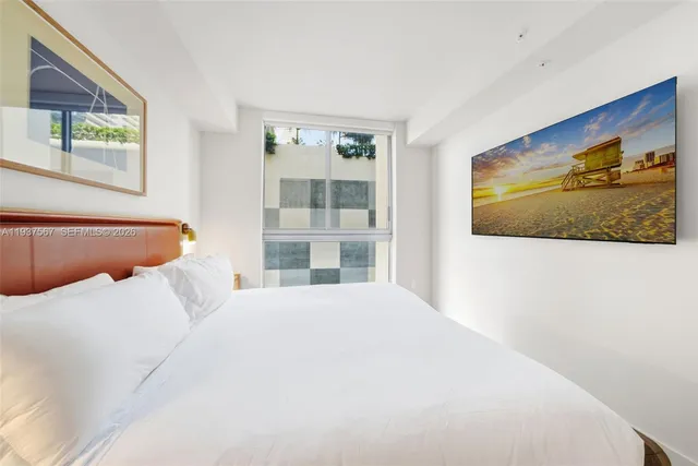 a bedroom with a bed and wall painting