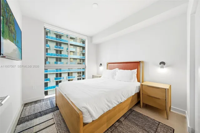 a bedroom with a bed and a book shelf