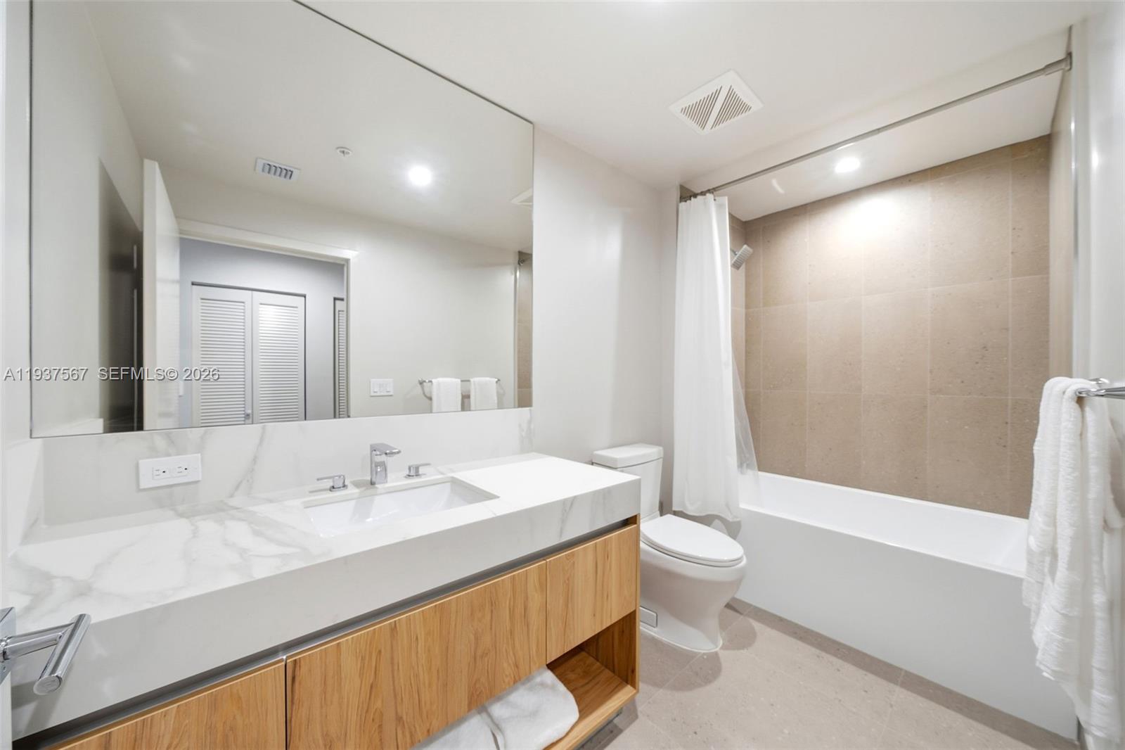 11 Northeast 6th Street, Unit 709 Miami, FL 33132 - Photo 19 of 54 a bathroom with a sink a toilet and shower