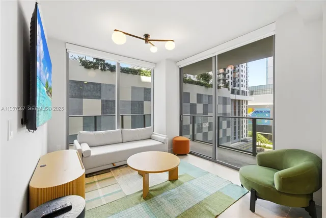 a living room with furniture and a large window