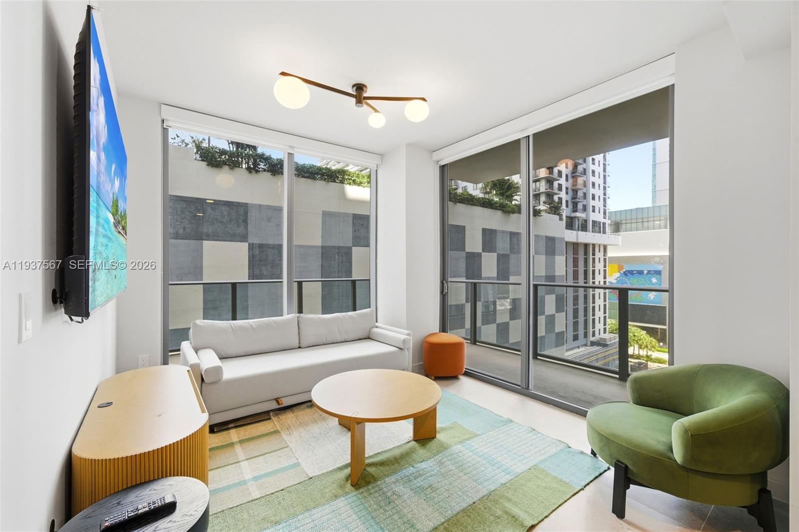 11 Northeast 6th Street, Unit 709 Miami, FL 33132 - Photo 2 of 54 a living room with furniture and a large window