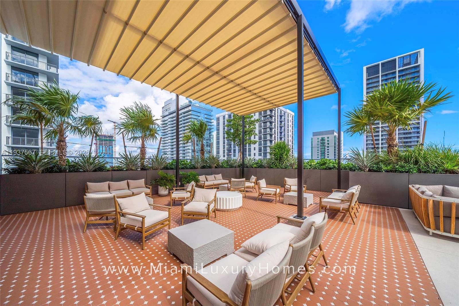11 Northeast 6th Street, Unit 709 Miami, FL 33132 - Photo 25 of 54 a view of a patio with couches and table and chairs and potted plants