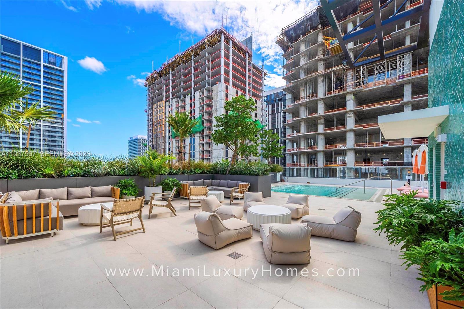 11 Northeast 6th Street, Unit 709 Miami, FL 33132 - Photo 26 of 54 a view of a patio with couches and a potted plant on a table and chairs