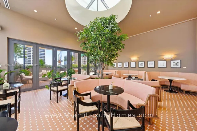 a dining room with furniture and a large window