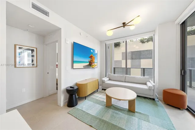 a living room with furniture and a large window