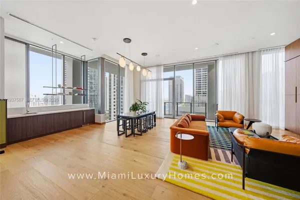 a living room with furniture and large windows