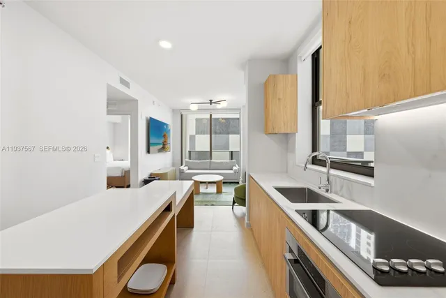 a kitchen with stainless steel appliances granite countertop a sink and cabinets