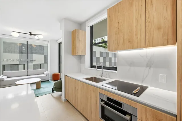 a view of a sink and a microwave oven in a room
