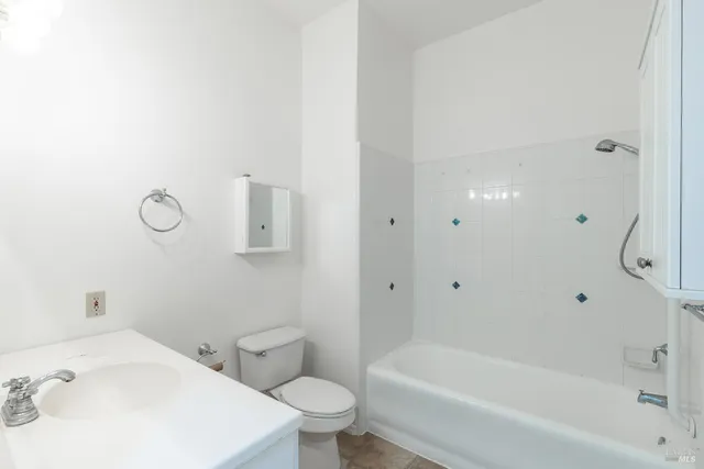 a white bath tub sitting next to a white toilet