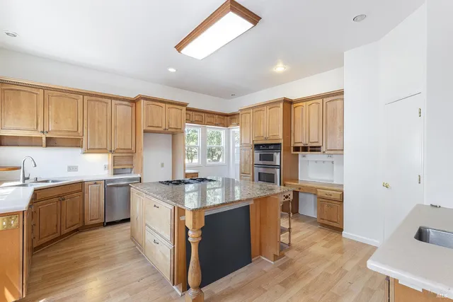 a kitchen with sink stove and cabinets