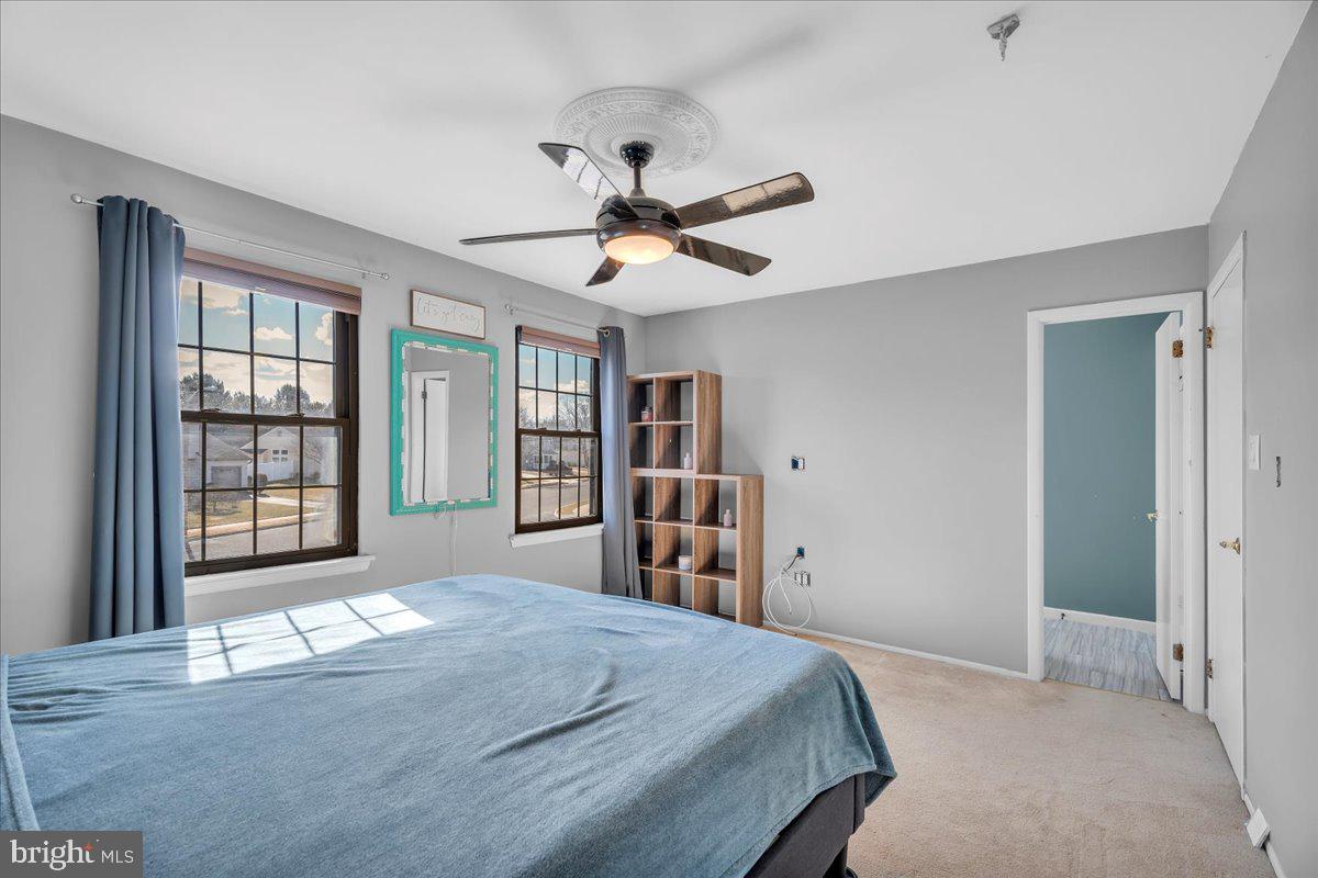 52 Borrelly Boulevard Sewell, NJ 08080 - Photo 16 of 24 a bedroom with a bed and a chandelier