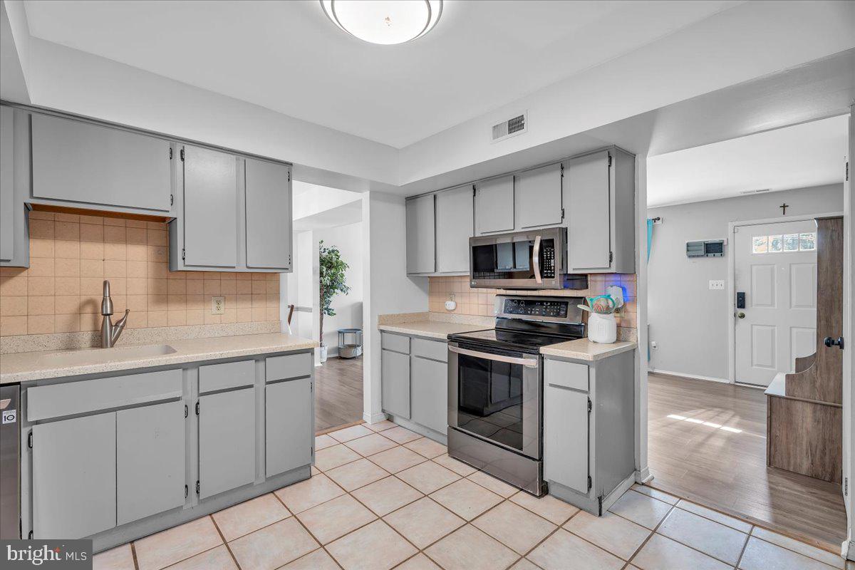 52 Borrelly Boulevard Sewell, NJ 08080 - Photo 6 of 24 a kitchen with white cabinets stainless steel appliances and a sink