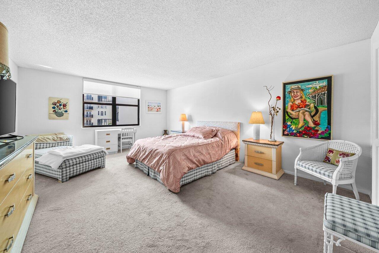 3460 South Ocean Boulevard, Unit 6150 Palm Beach, FL 33480 - Photo 12 of 34 a spacious bedroom with a bed and a couch