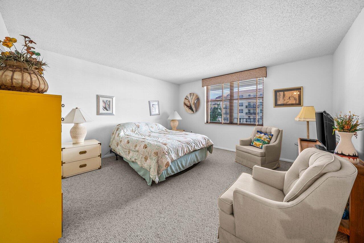 3460 South Ocean Boulevard, Unit 6150 Palm Beach, FL 33480 - Photo 17 of 34 a bedroom with bed and window