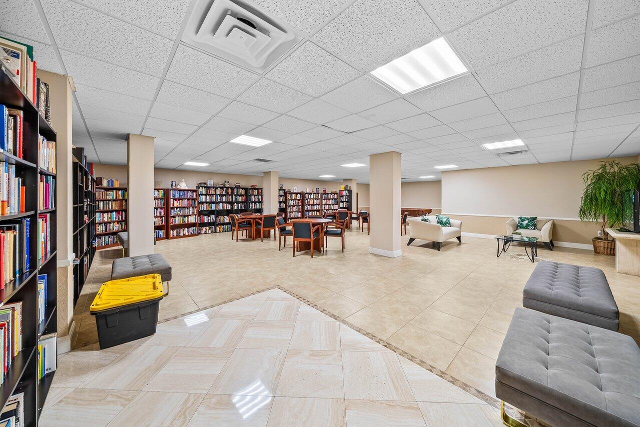 3460 South Ocean Boulevard, Unit 6150 Palm Beach, FL 33480 - Photo 24 of 34 a gym room with lots of furniture and a flat screen tv