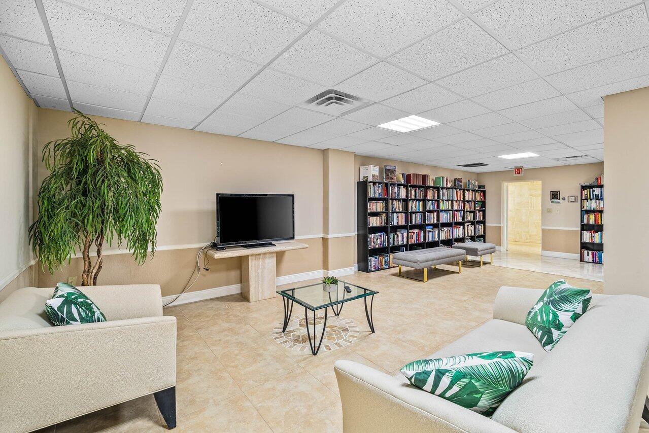 3460 South Ocean Boulevard, Unit 6150 Palm Beach, FL 33480 - Photo 26 of 34 a living room with furniture and a flat screen tv