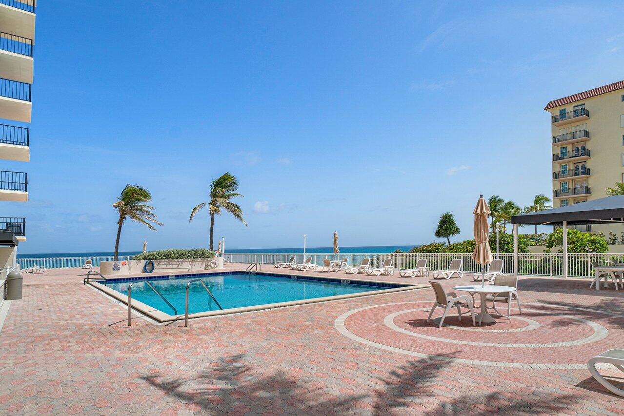 3460 South Ocean Boulevard, Unit 6150 Palm Beach, FL 33480 - Photo 29 of 34 a swimming pool with outdoor seating