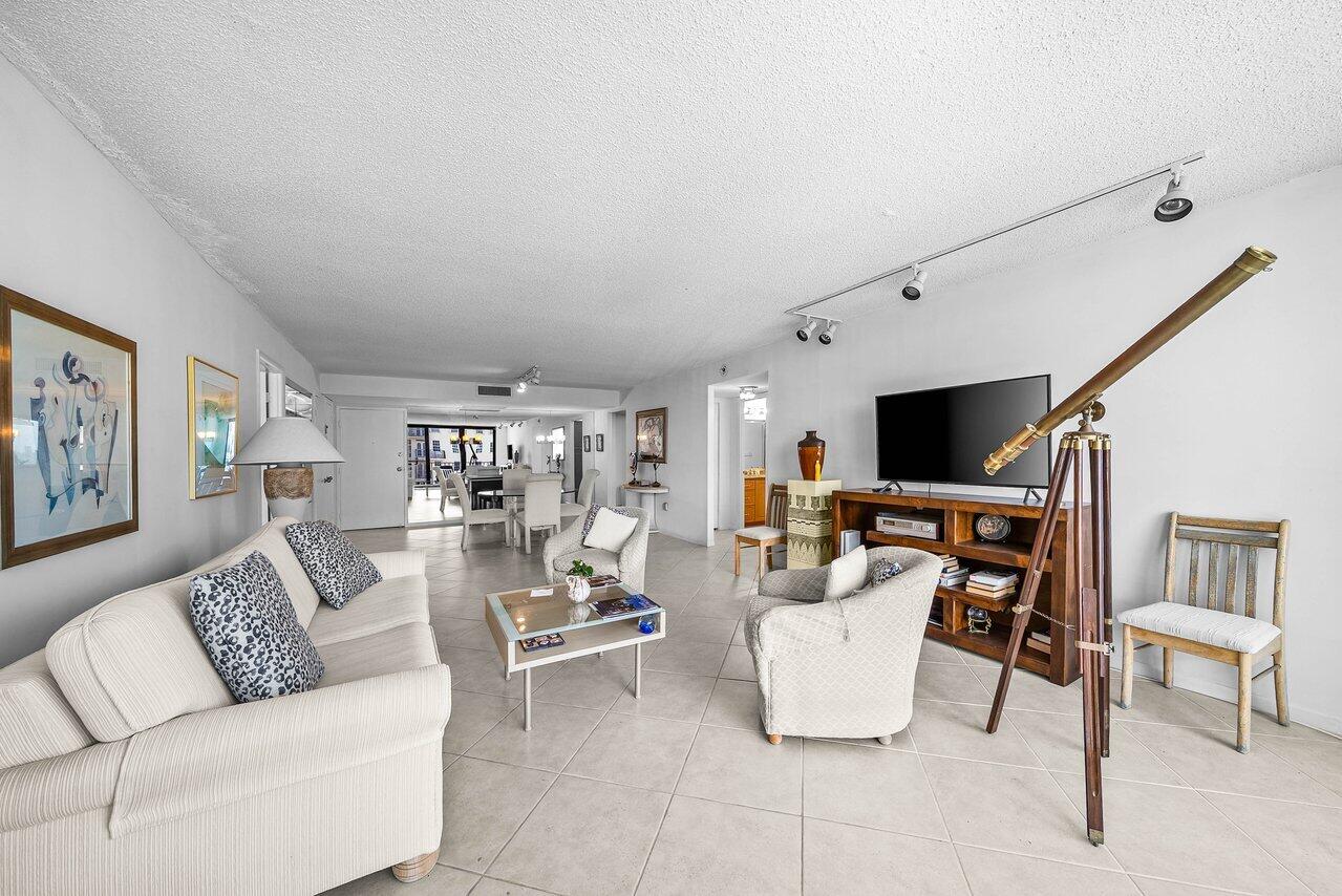 3460 South Ocean Boulevard, Unit 6150 Palm Beach, FL 33480 - Photo 7 of 34 a living room with furniture and a flat screen tv