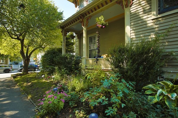 45 Orchard Street, Unit 1 Boston, MA 02130 - Photo 15 of 19 a view of a house with a tree and flower plants