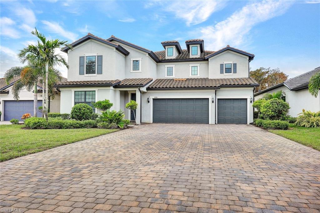 19176 Elston Way Estero, FL 33928 - Photo 1 of 26 a front view of a house with a garden and trees